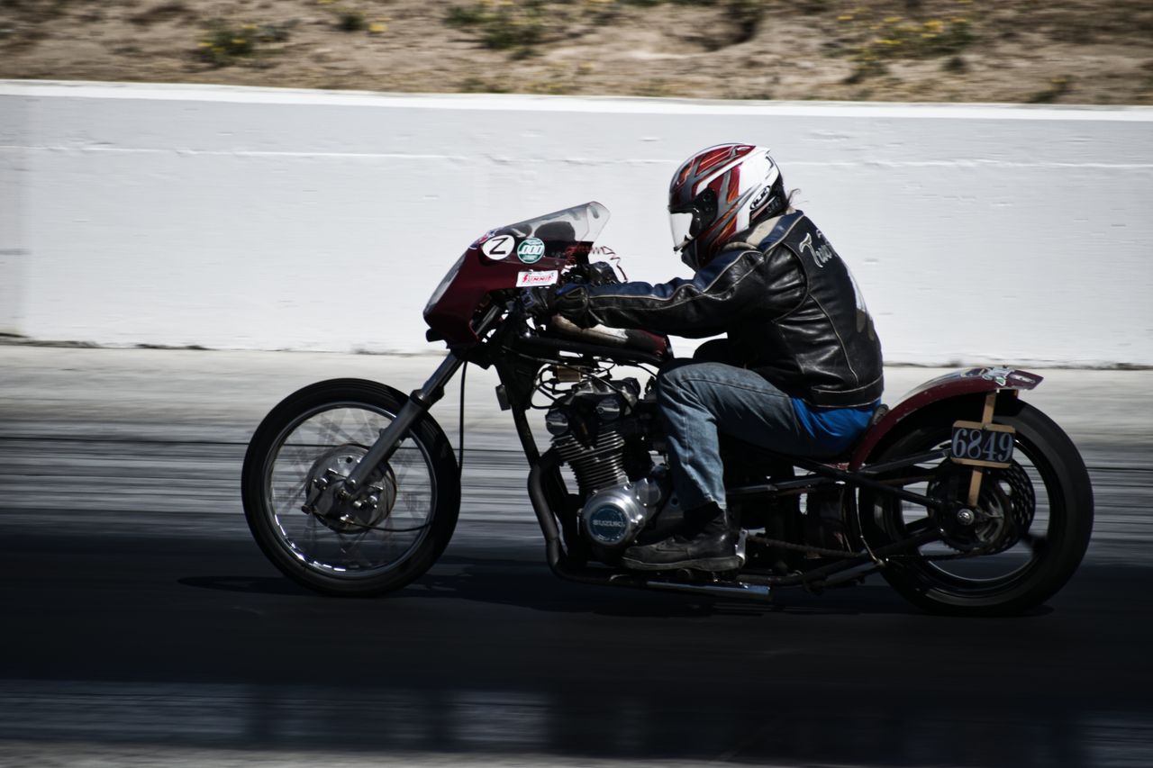 gallery-1 Motorcyclist racing at high speed on a smooth track, showcasing skill and precision.