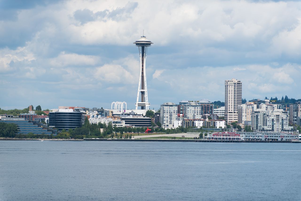 services-04 A scenic view of the Seattle skyline featuring the iconic Space Needle against a cloudy sky.